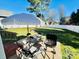 Outdoor patio area featuring a table, chairs, grill, and an umbrella for shade, perfect for outdoor dining at 435 Riverwalk Nw Dv, Concord, NC 28027