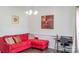 Cozy sitting room featuring bright red sectional sofa and contemporary decor at 435 Riverwalk Nw Dv, Concord, NC 28027