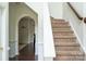 Inviting staircase with carpeted steps and a wooden handrail, leading to the upper level of the home at 435 Riverwalk Nw Dv, Concord, NC 28027