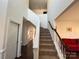 Inviting foyer showcasing a carpeted staircase and hardwood floors to an inviting living room at 435 Riverwalk Nw Dv, Concord, NC 28027