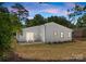 The backyard features a patio with a table and chairs and nice green grass at 4562 Rockford Ct, Charlotte, NC 28209