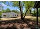 Back exterior of home featuring a patio and large tree in backyard at 4562 Rockford Ct, Charlotte, NC 28209