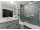 Stylish bathroom features a modern vanity, sleek fixtures, and a glass-enclosed shower with eye-catching geometric tile at 4562 Rockford Ct, Charlotte, NC 28209