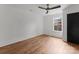 Clean and simple bedroom with modern ceiling fan, fresh paint, hardwood floors, and bright window at 4562 Rockford Ct, Charlotte, NC 28209