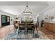 Elegant dining room showcasing an open layout with kitchen views, stylish furnishings, and a modern chandelier at 4562 Rockford Ct, Charlotte, NC 28209