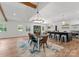 Bright dining area with a modern chandelier, open kitchen views, and stylish seating creating an inviting atmosphere at 4562 Rockford Ct, Charlotte, NC 28209