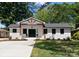 Charming single-story home featuring a brick facade, updated landscaping, and a inviting front porch at 4562 Rockford Ct, Charlotte, NC 28209