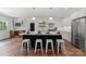 Spacious kitchen featuring a large island, stainless steel appliances, and pendant lighting at 4562 Rockford Ct, Charlotte, NC 28209
