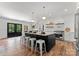 Modern kitchen with large island, pendant lighting, and stainless steel appliances at 4562 Rockford Ct, Charlotte, NC 28209