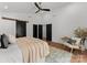 Spacious primary bedroom featuring hardwood floors, a ceiling fan, and a decorative sliding barn door at 4562 Rockford Ct, Charlotte, NC 28209