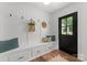 Inviting mudroom with white bench seating, storage drawers, and stylish decor, offering a functional and organized entryway at 4562 Rockford Ct, Charlotte, NC 28209