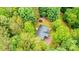An aerial view of the home featuring the roof, wooded surroundings and other outbuildings at 51 Emily Ln, Taylorsville, NC 28681