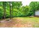 View of the backyard including a fire pit and a view to the bordering forest at 51 Emily Ln, Taylorsville, NC 28681