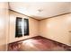 Bedroom featuring tan walls, brown carpet, and dark trim at 51 Emily Ln, Taylorsville, NC 28681