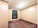 Bedroom with tan walls, brown carpet, and dark trim at 51 Emily Ln, Taylorsville, NC 28681