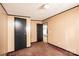 Bedroom with tan walls, brown carpet, and black door at 51 Emily Ln, Taylorsville, NC 28681