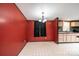 Cozy dining area with red accent wall and access to the kitchen at 51 Emily Ln, Taylorsville, NC 28681
