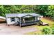 Inviting single-story home with a covered porch, black railings, and natural landscape at 51 Emily Ln, Taylorsville, NC 28681