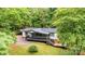 Charming single-story home with a metal roof, front deck, and wooded surroundings at 51 Emily Ln, Taylorsville, NC 28681