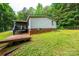 Exterior view of the back of the home, with deck, stairs, and covered porch at 51 Emily Ln, Taylorsville, NC 28681
