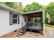View of the front porch with wood railings and an American flag at 51 Emily Ln, Taylorsville, NC 28681