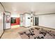Open-concept living area with neutral walls, carpet, and easy access to other rooms at 51 Emily Ln, Taylorsville, NC 28681