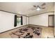 Bright living room featuring neutral walls, plush carpeting, and a ceiling fan at 51 Emily Ln, Taylorsville, NC 28681