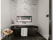 Beautiful black soaking tub with accent fireplace and marble tile in renovated modern bathroom at 5432 Carmel Rd, Charlotte, NC 28210
