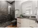 A modern bathroom featuring a sleek, glass-enclosed shower, and a floating vanity with elegant fixtures at 5432 Carmel Rd, Charlotte, NC 28210