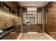 Custom butlers pantry features warm wood cabinets, lighting, shelves, sink, and drawers at 5432 Carmel Rd, Charlotte, NC 28210