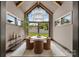 Bright dining room features vaulted ceiling, large windows, modern chandelier, and backyard views at 5432 Carmel Rd, Charlotte, NC 28210