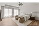 Bright main bedroom with hardwood floors, tray ceiling, sitting area, and sheer curtains at 5432 Carmel Rd, Charlotte, NC 28210
