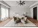 Bright main bedroom with hardwood floors, tray ceiling, sitting area, and neutral decor at 5432 Carmel Rd, Charlotte, NC 28210