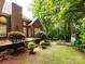 View of the backyard of a brick home with plants and mulched landscaping at 5816 Valley Stream Trl, Waxhaw, NC 28173