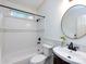 Bright bathroom features white tile, shower and tub, and a modern vanity with black fixtures at 5816 Valley Stream Trl, Waxhaw, NC 28173