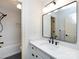 Stylish bathroom featuring a modern vanity, large mirror, and a shower/tub combo at 5816 Valley Stream Trl, Waxhaw, NC 28173