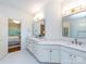 Bright bathroom with marble floors, dual vanity with gold fixtures, and access to the main bedroom at 5816 Valley Stream Trl, Waxhaw, NC 28173