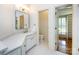 Bathroom featuring a sink, vanity, toilet, and walk-in closet for optimal storage and convenience at 5816 Valley Stream Trl, Waxhaw, NC 28173
