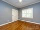 Bedroom with hardwood floors, window with shutters, and a ceiling fan at 5816 Valley Stream Trl, Waxhaw, NC 28173