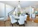 Bright dining area with views of the staircase, living room, and a modern geometric chandelier at 5816 Valley Stream Trl, Waxhaw, NC 28173
