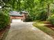 View of the side of the brick home with a two car garage and driveway at 5816 Valley Stream Trl, Waxhaw, NC 28173