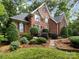 Inviting brick home with manicured landscaping, stone pathway, and lush green lawn at 5816 Valley Stream Trl, Waxhaw, NC 28173
