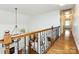 Elegant foyer with hardwood floors and iron railing overlooking the living space at 5816 Valley Stream Trl, Waxhaw, NC 28173