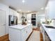 Well-lit kitchen with white cabinetry, stainless steel appliances, and a center island at 5816 Valley Stream Trl, Waxhaw, NC 28173