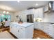 Bright kitchen features a center island, stainless steel appliances, and hardwood floors at 5816 Valley Stream Trl, Waxhaw, NC 28173