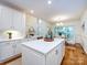 Bright kitchen with white cabinets, stainless appliances, quartz countertops, and hardwood flooring at 5816 Valley Stream Trl, Waxhaw, NC 28173