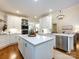 Spacious white kitchen with stainless steel appliances, quartz countertops, and modern fixtures at 5816 Valley Stream Trl, Waxhaw, NC 28173