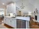 Modern kitchen featuring white cabinets, stainless appliances, and an open design layout at 5816 Valley Stream Trl, Waxhaw, NC 28173
