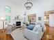 Bright and airy living room featuring high ceilings, a fireplace, and an open view to the kitchen area at 5816 Valley Stream Trl, Waxhaw, NC 28173