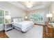 Bright main bedroom featuring hardwood floors, large windows, and elegant furnishings at 5816 Valley Stream Trl, Waxhaw, NC 28173